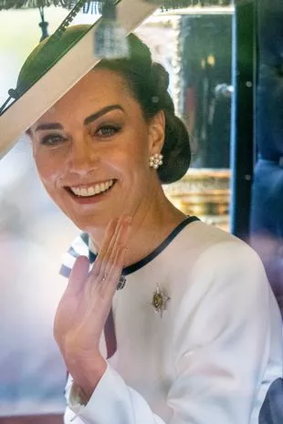 Kate waved from the carriage