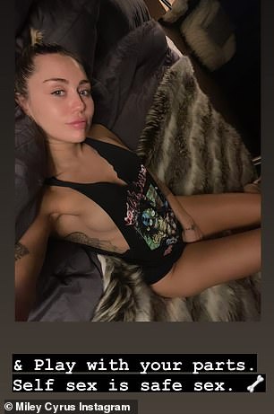 Braless: Miley Cyrus flashed her sideboob in nothing but a Motley Crue tank top as she proclaimed 'self sex is safe sex' on Instagram on Tuesday