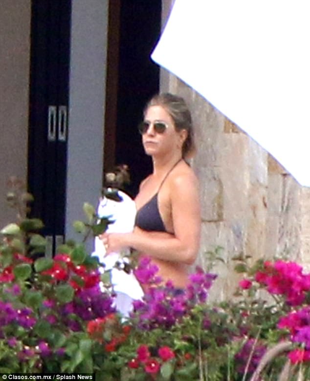 Making a splash: Jennifer Aniston showed off her impressively toned physique while poolside in Mexico on Friday morning