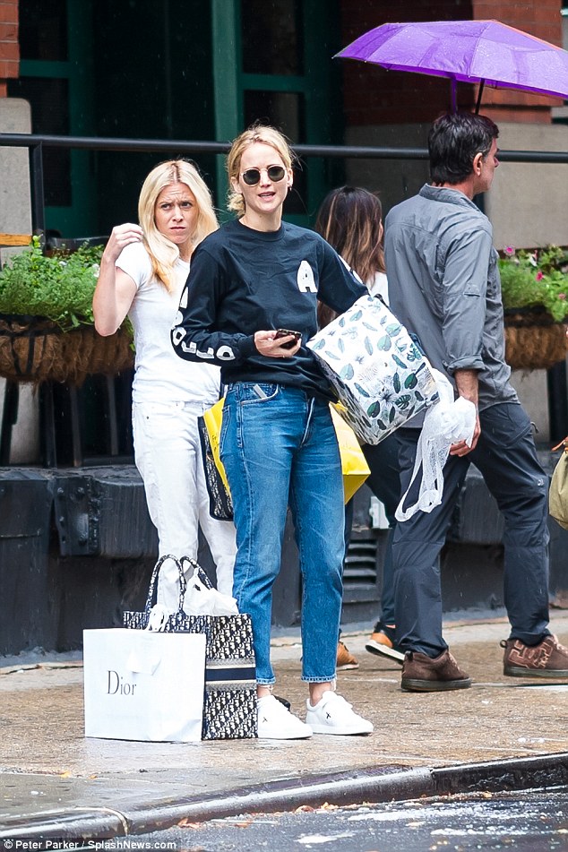 Out and about: Jennifer Lawrence, 28, was snapped shopping in New York City clad in a long-sleeved navy blue top with blue jeans with white sneakers 