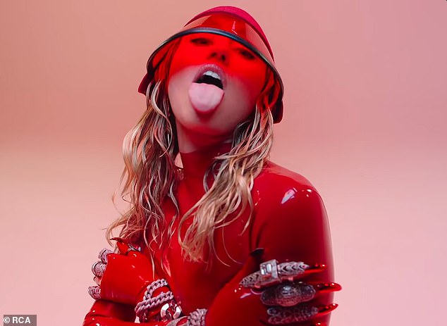 Lady in red: The red latex was the first of a few bold looks the artist formerly known as Hannah Montana rocked in the video