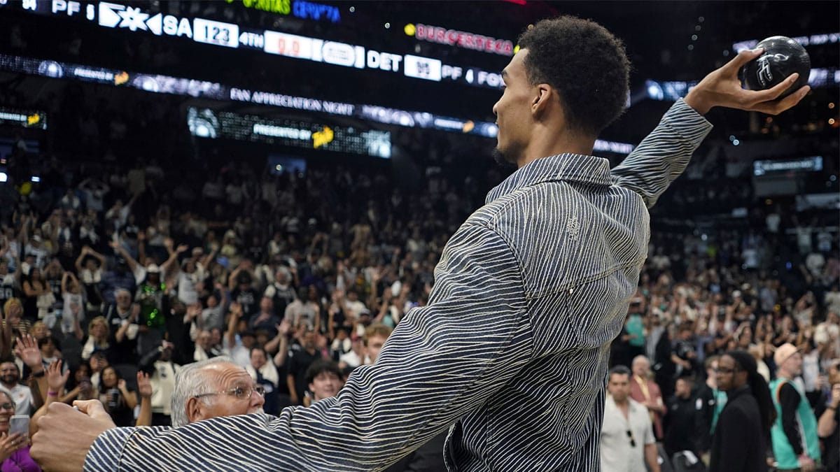 San Antonio Spurs forward Victor Wembanyama (1) throws a ball to fans after the final game of the season against the Detroit Pistons at Frost Bank Center.