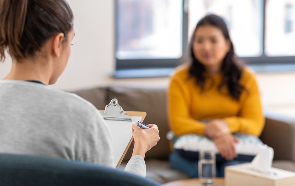 woman in yellow jumper receiving therapy