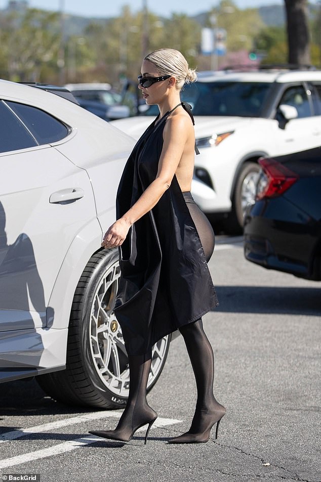 Kim paired the Balenciaga top with black leggings featuring built-in heels from the same fashion house, while Bianca wore gray leggings and sparkling silver detached mule heels