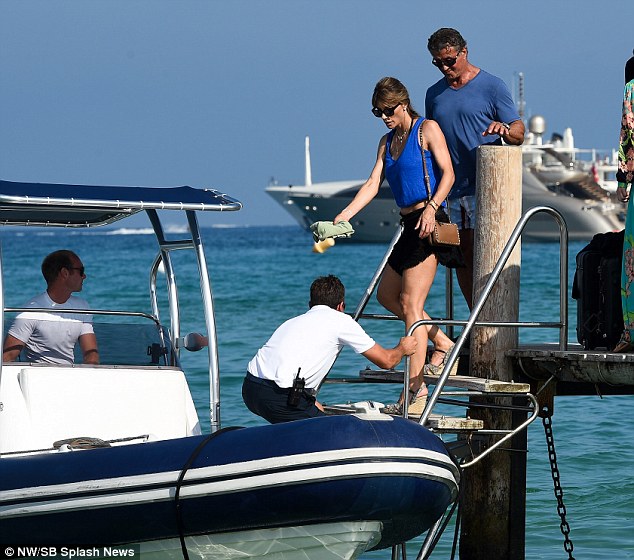 On you go: The pair were seen making their way onto the speed boat with help from some staff