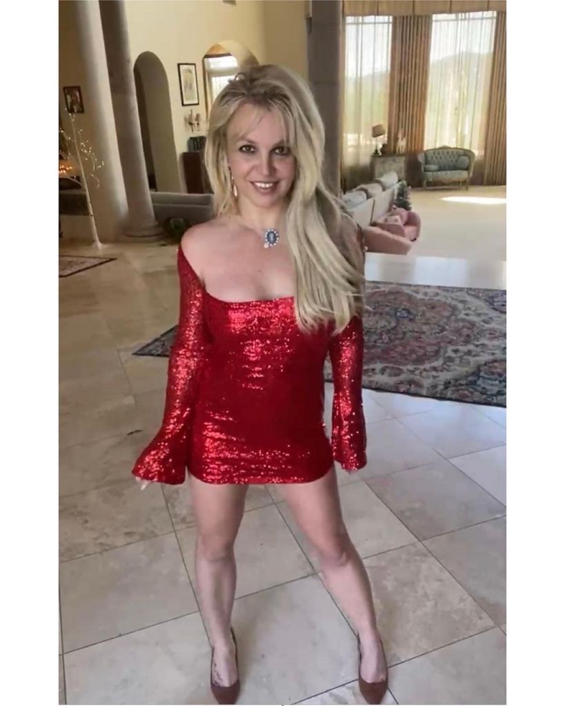 Britney Spears posing in a red dress