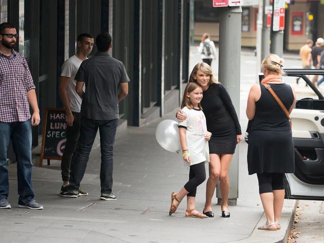 Taylor Swift poses with a fan in Surry Hills yesterday, so (inset) her mother could take a photograph. Picture: Media Mode/INF