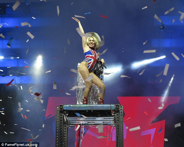 Tribute: The singer wore a blonde wig under the cowboy hat for the uplifting performance