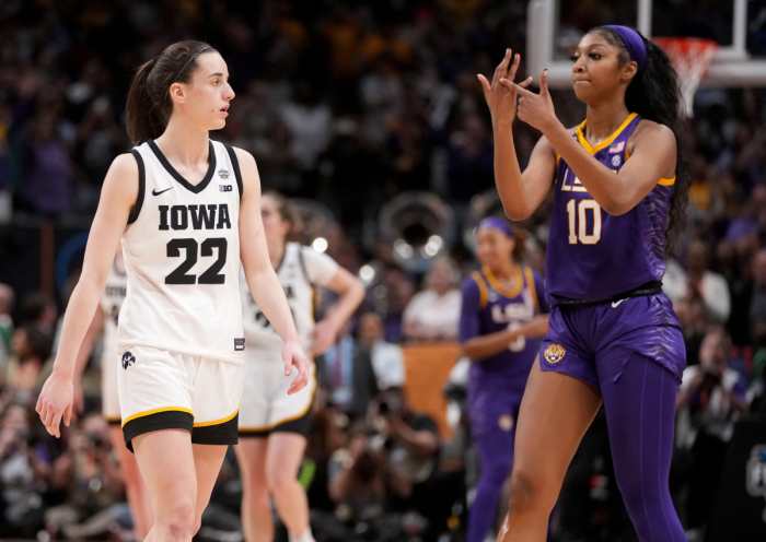 Angel Reese (10) shows Iowa Caitlin Clark her ring finger during the final seconds of the women's 2023 NCAA Tournament national championship game. 