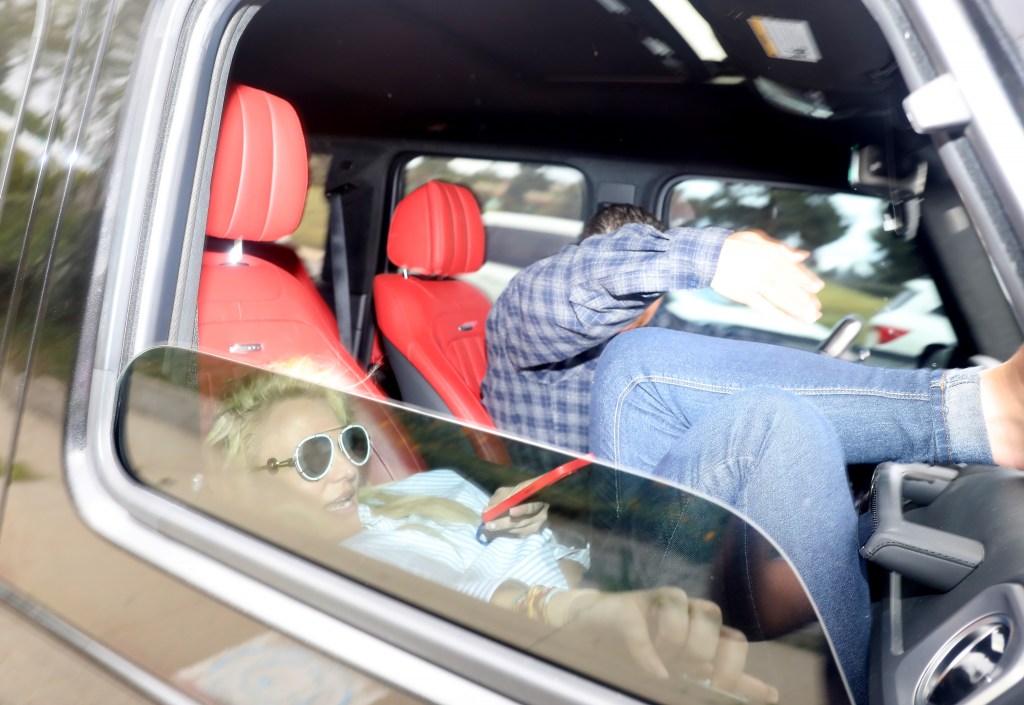 Britney Spears lying down in a car