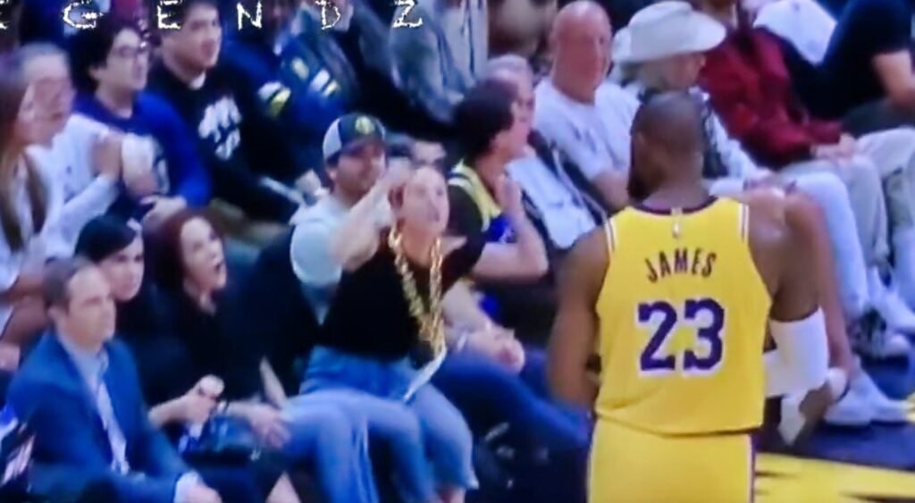 LeBron James looking at Nuggets fan courtside