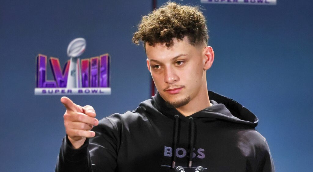 Patrick Mahomes in hoodie speaking to reporters