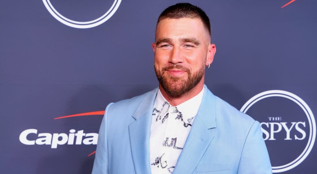 Travis Kelce posing in blue suit