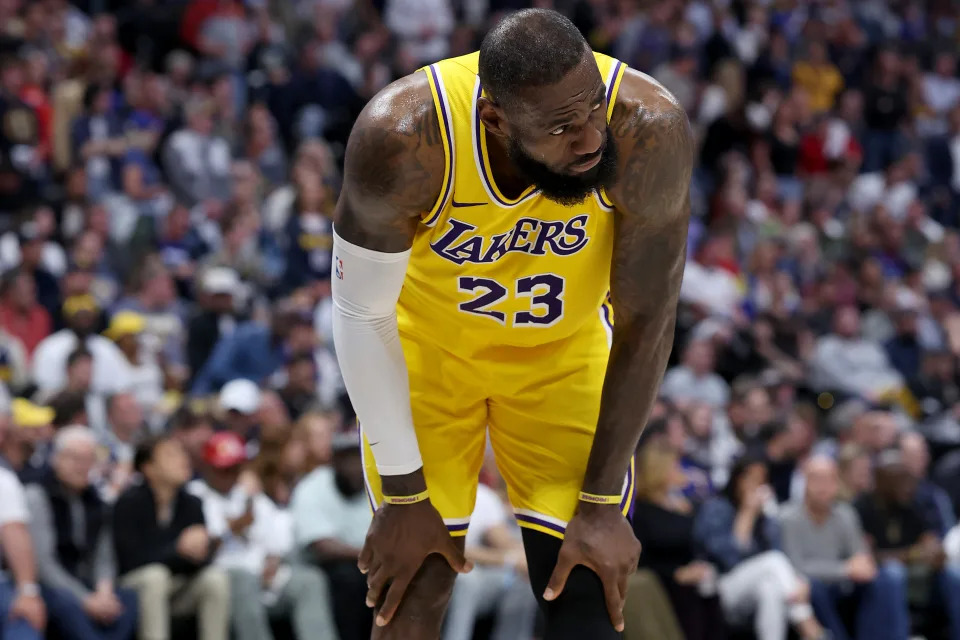 DENVER, COLORADO - APRIL 29: LeBron James #23 of the Los Angeles Lakers gathers himself after taking a hard hit while playing the Denver Nuggets in the third quarter during game five of the Western Conference First Round Playoffs at Ball Arena on April 29, 2024 in Denver, Colorado. NOTE TO USER: User expressly acknowledges and agrees that, by downloading and or using this photograph, User is consenting to the terms and conditions of the Getty Images License Agreement. (Photo by Matthew Stockman/Getty Images)