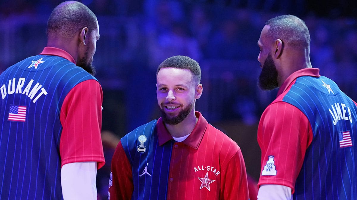 Western Conference guard Stephen Curry (30) of the Golden State Warriors talks with forward Kevin Durant (35) of the Phoenix Suns and forward LeBron James (23) of the Los Angeles Lakers before the 73rd NBA All Star game at Gainbridge Fieldhouse.