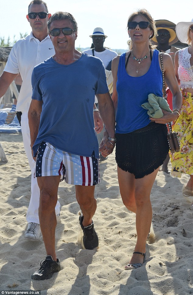 Hand in hand: The happy couple couldn't help but draw a crowd during their beach day in St Tropez