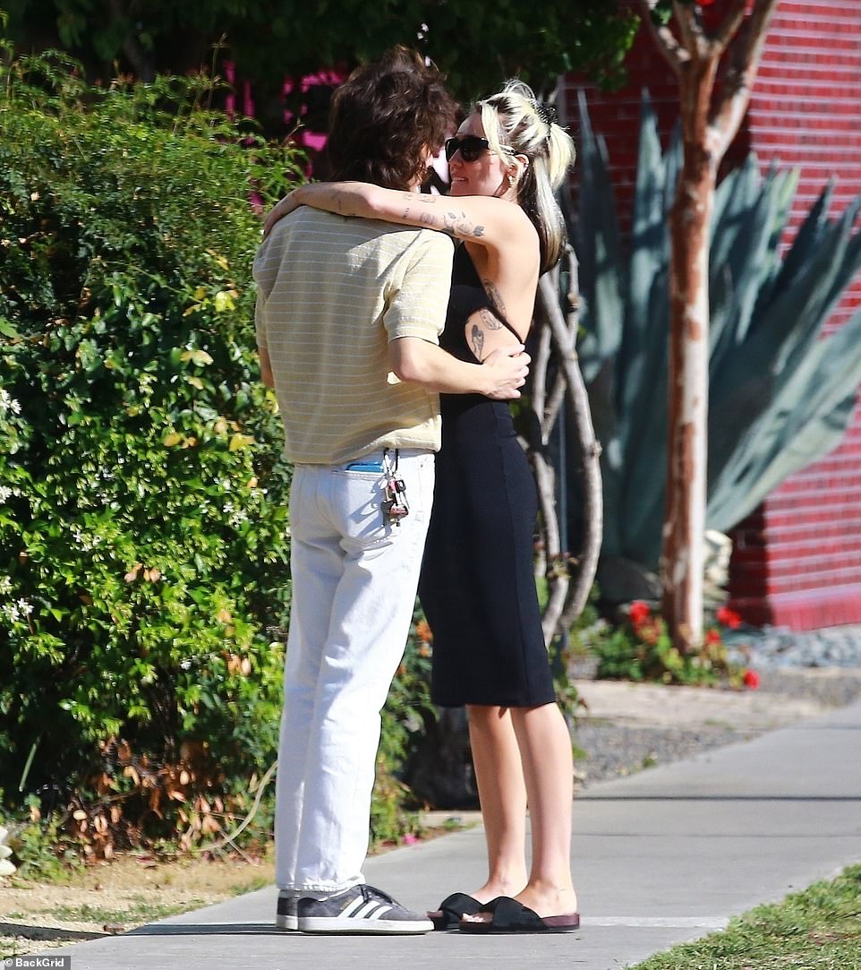 Taking it easy: Maxx was dressed in a summery pale yellow shirt with thin white stripes, which he complemented with white jeans. He wore his long brown hair in a shaggy mop, and he completed the relaxed look with gray Adidas sneakers