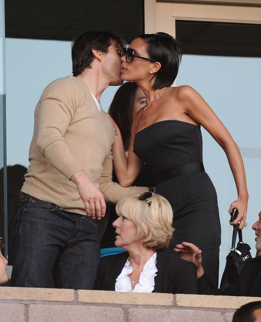 Tom Cruise kisses Victoria Beckham on the cheek.