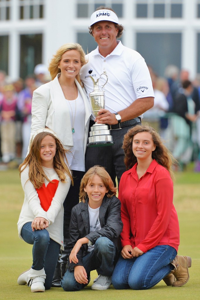 Family man Mickelson holds the Claret Jug with wife, Amy, and children, Evan, Amanda and Sophia, after winning the 142nd Open Championship in 2013.