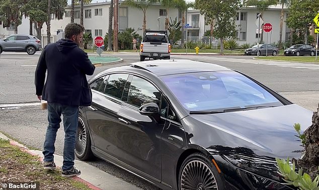 He opened his door for his wife, who sat in the passenger seat, and he then shut the door firmly by dramatically swinging his arm, before walking over to the driver's seat