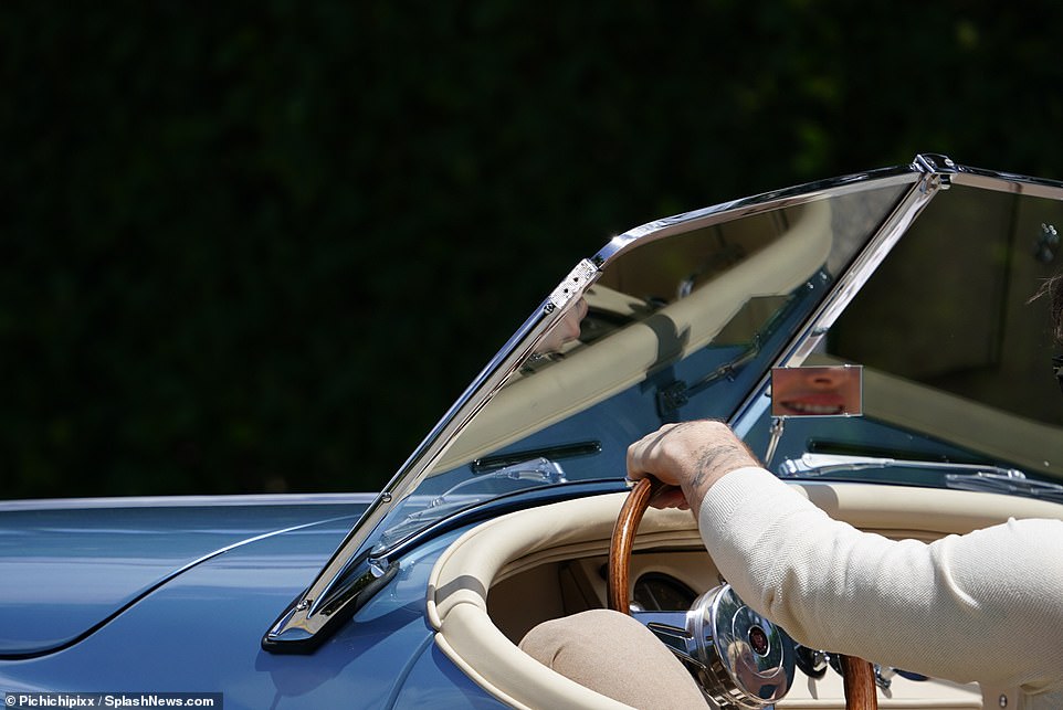 Shiny: The former photographer could be seen wearing a dazzling silver wedding ring as he maneuvered the car's wheel