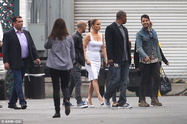 The team: JLo was flanked by a series of staff including a body guard and her make-up artist