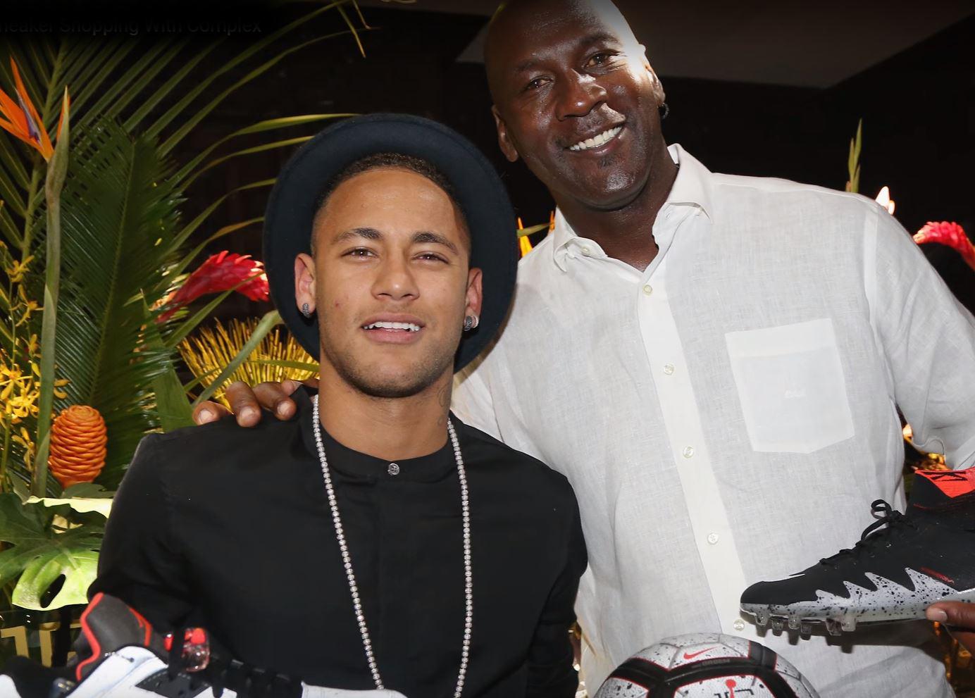  Neymar poses with Michael Jordan after the NBA star gave him a line of Air Jordan trainers