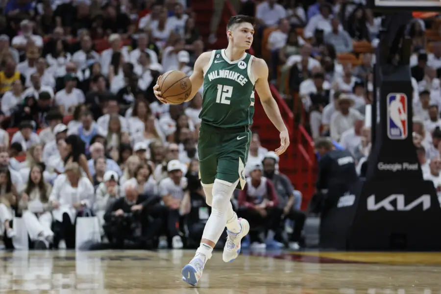 Apr 22, 2023; Miami, Florida, USA; Milwaukee Bucks guard Grayson Allen (12) dribbles the basketball in the second quarter against the Miami Heat during game three of the 2023 NBA Playoffs at Kaseya Center. Mandatory Credit: Sam Navarro-USA TODAY Sports