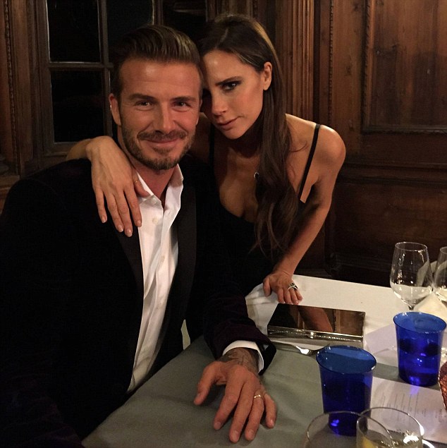 Retired English footballer David Beckham and his wife Victoria Beckham strike a pose at a dinner in Scotland in 2014