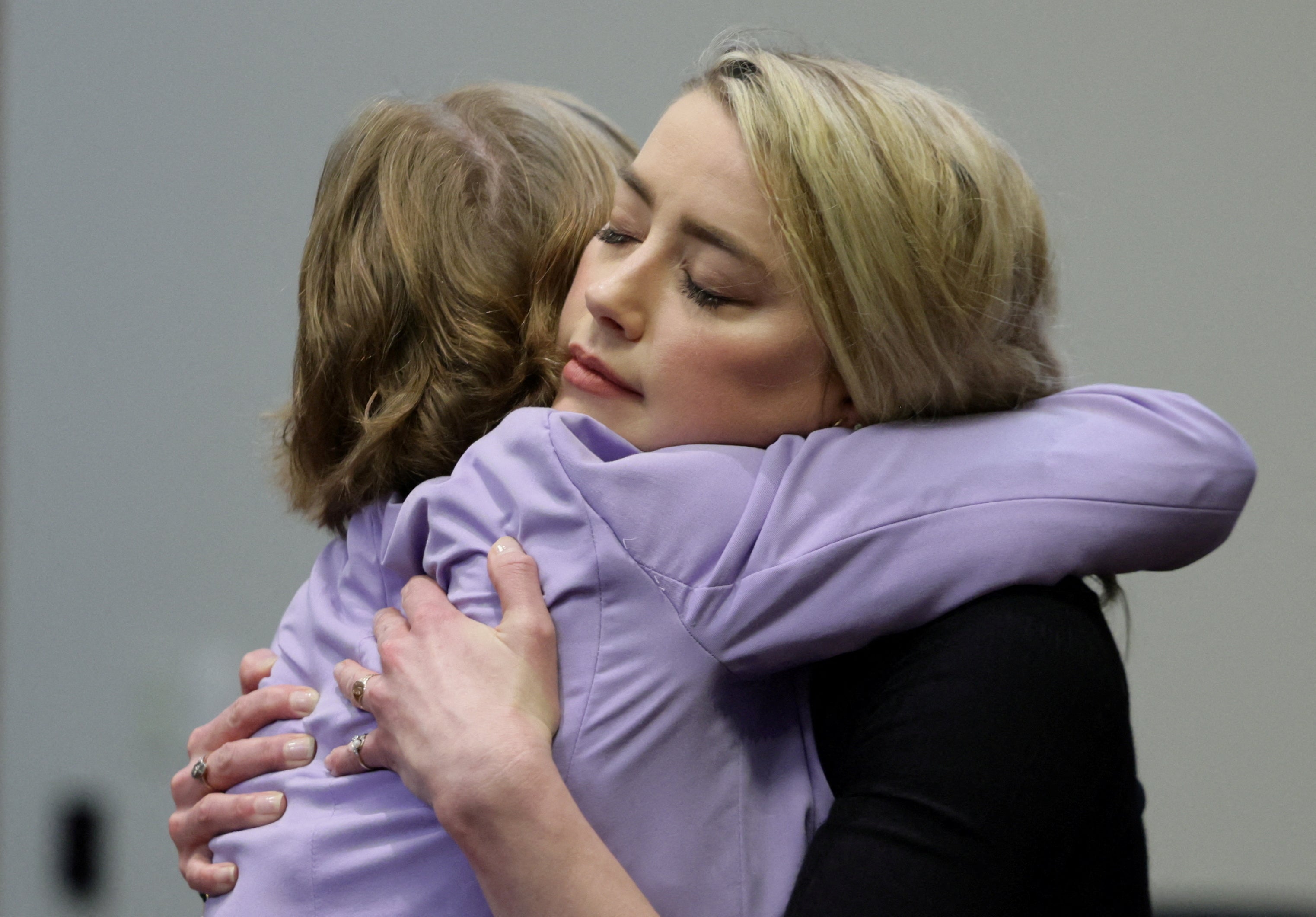 Amber Heard and Elaine Bredehoft hug after the jury’s ruling