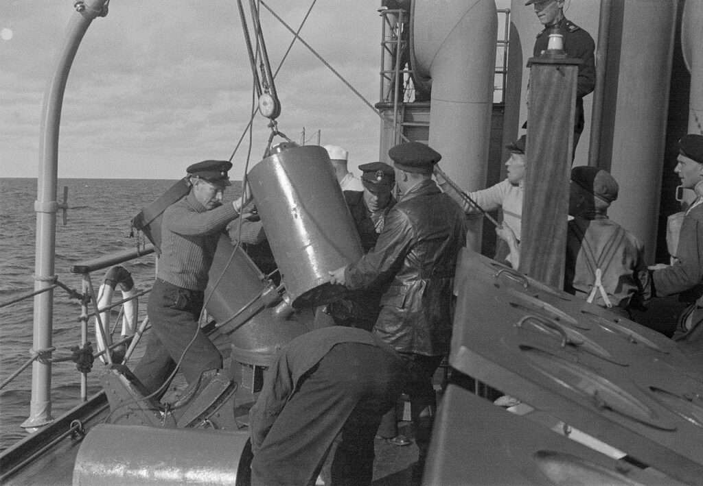 Sailors loading depth charges, 30 August 1942. 