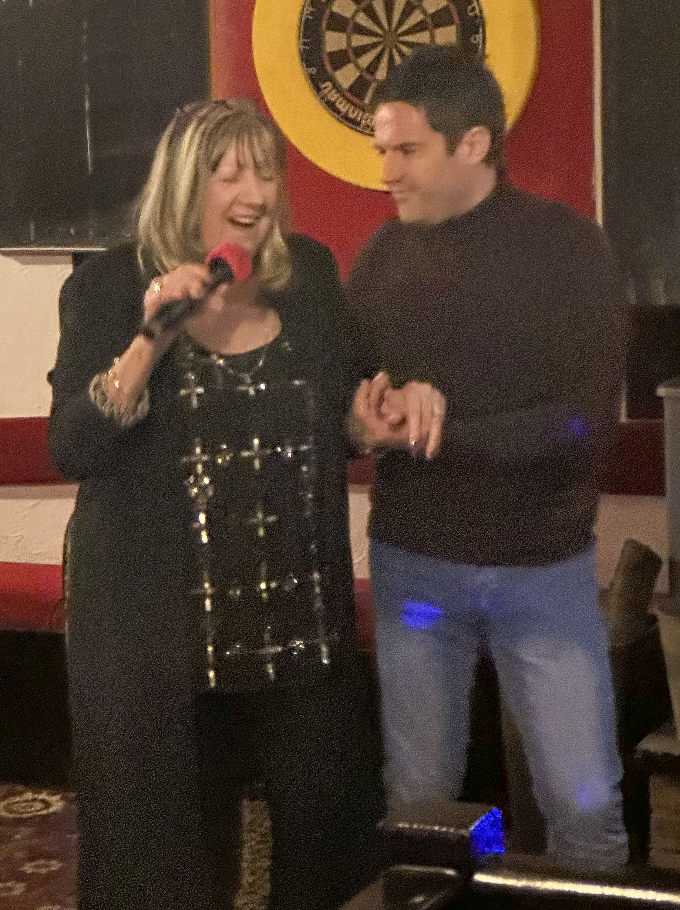 George Gilbey and mum Linda hold hands as they are pictured performing karaoke at Oakmead Social Club in St Osyth, Essex