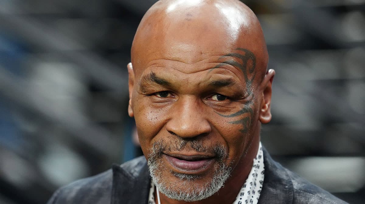 Mike Tyson poses for a photo on the sidelines before the start of a game between the Las Vegas Raiders and the Pittsburgh Steelers at Allegiant Stadium