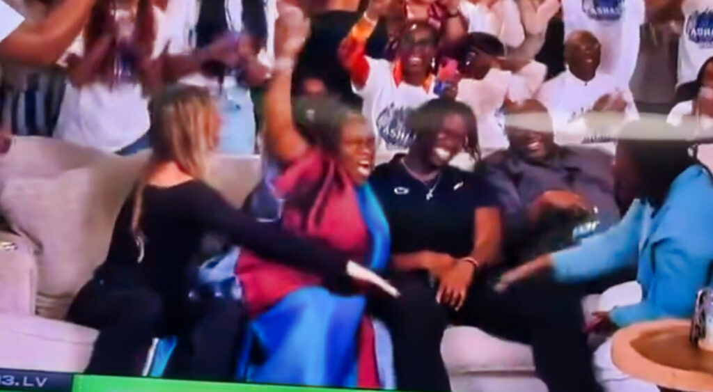 Olu Fashanu sitting next to his mother and girlfriend