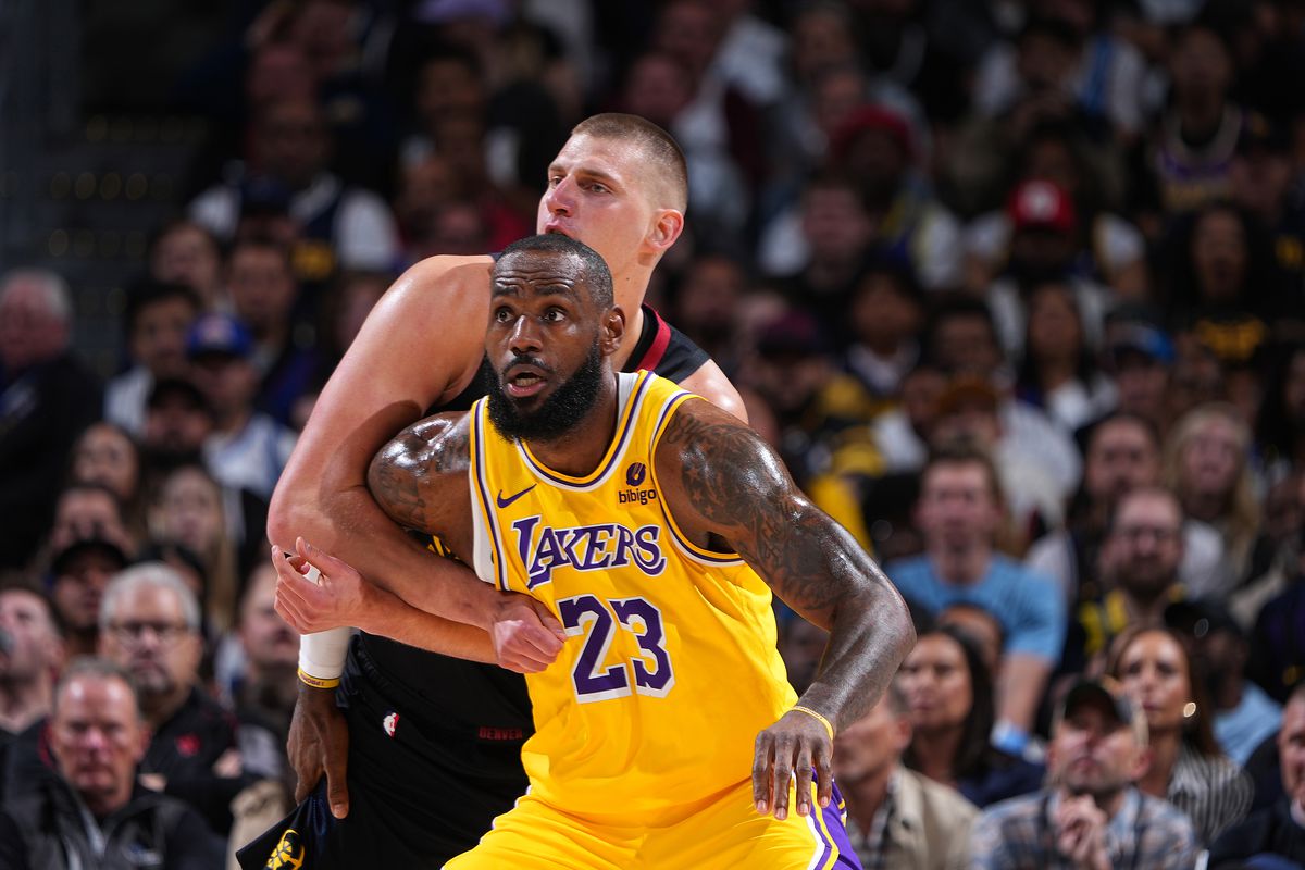 LeBron James in front of Nikola Jokić, boxing him out. 