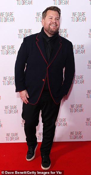 Stylish: He donned a black blazer with red trimmings