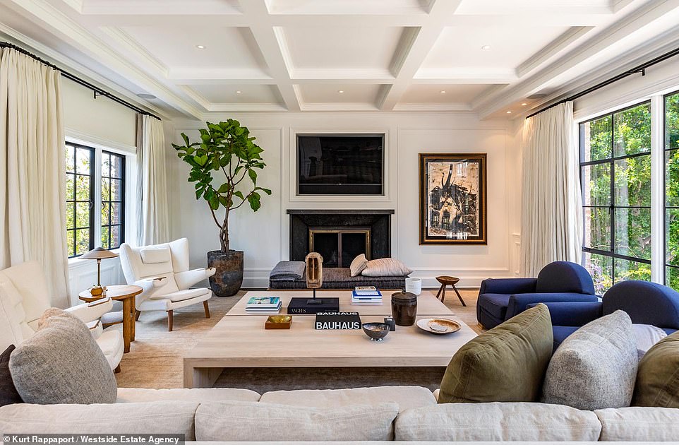 Lush: A formal dining room with its own bar leads into a gourmet kitchen with stainless steel appliances offering a modern contrast to the gorgeous wooden floors