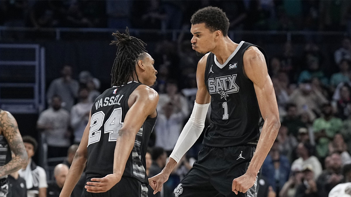 San Antonio Spurs forward Victor Wembanyama (1) and guard Devin Vassell (24) react during overtime against the Brooklyn Nets at Moody Center.