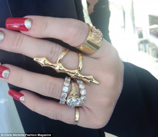 The bling ring: Miley shows off her impressive jewellery at the Fashion Magazine shoot