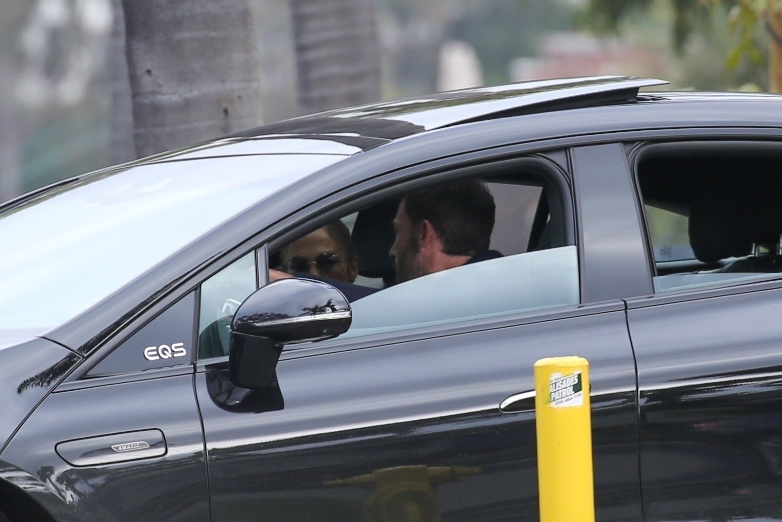 Jennifer Lopez and Ben Affleck inside of a car.