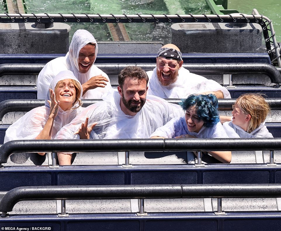 All smiles: The couple had a blast as they went on some rides, including The Jurassic World ride with Lopez's daughter Emme, 13, and Affleck's son Samuel, nine