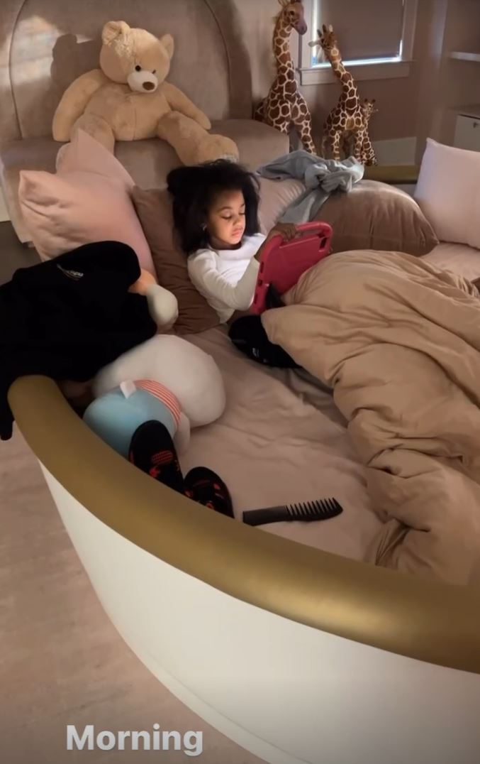 The little girl had a lavish bed covered in giant stuffed animals