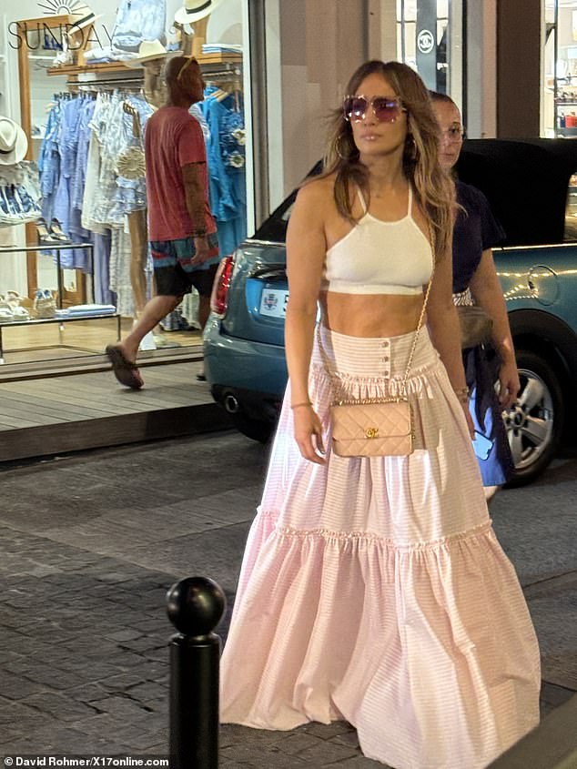 Lopez was seen Thursday in a cropped white top and striped pink maxi skirt while out shopping in St. Barts