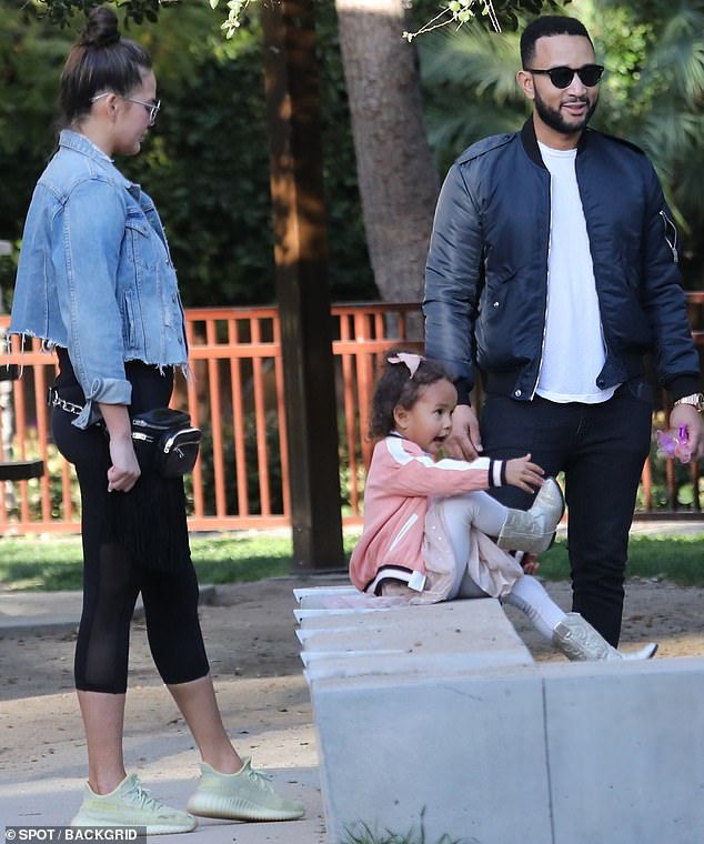 Meanwhile: Her Academy Award-winning husband wore a fashionable navy bomber jacket over a white T-shirt and a pair of dark jeans