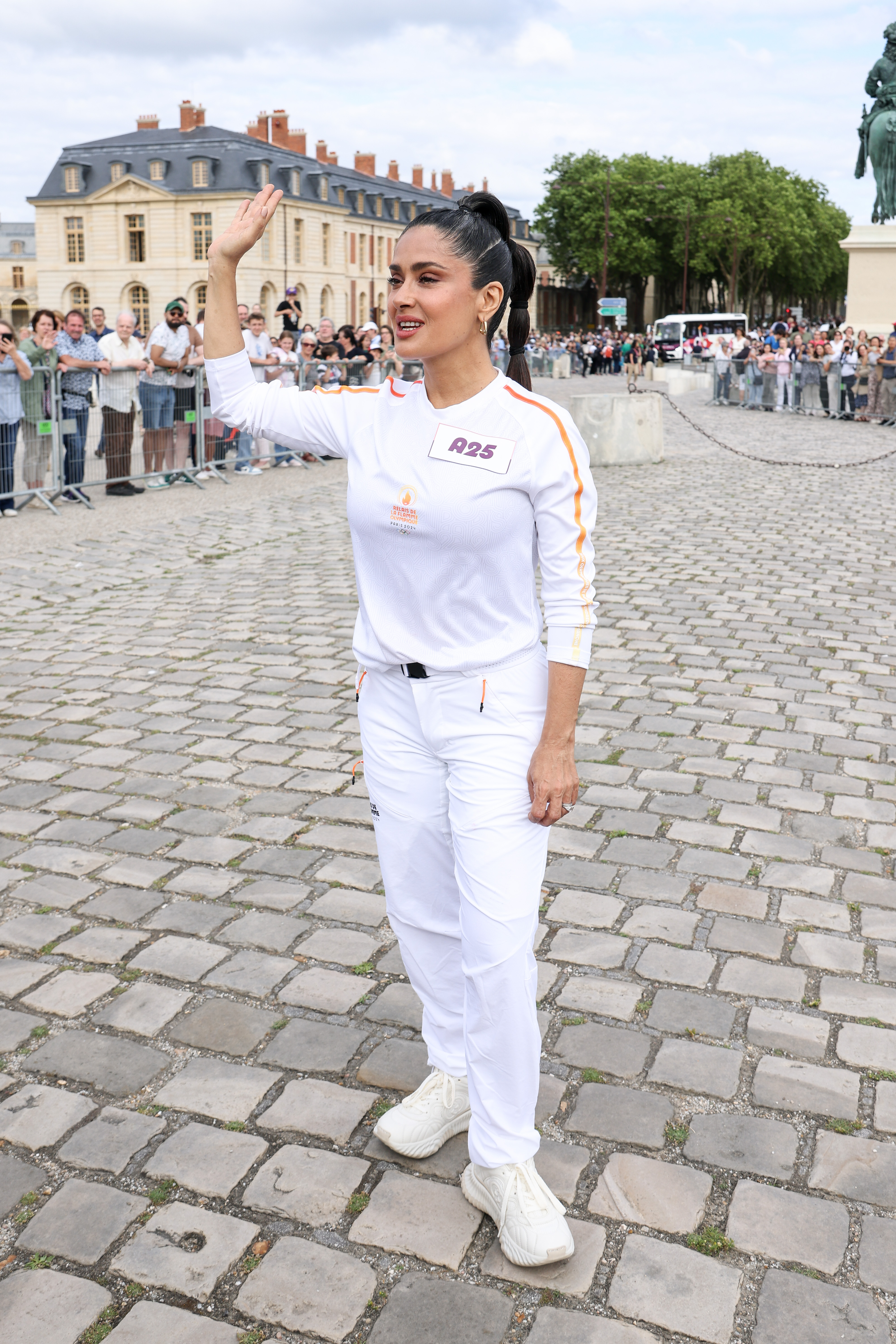 Salma Hayek runs during the Paris Olympics torch relay in Versailles, France, on July 23, 2024 | Source: Getty Images