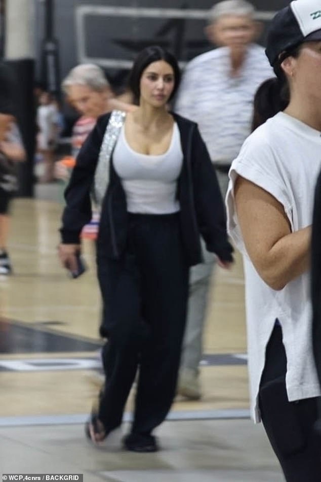 Kim had on baggy black sweatpants and an oversized black zip-up hoodie over a white tank top