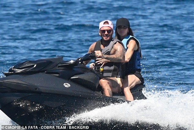 David took control as he took his wife out for a spin on the jet ski during the family holiday