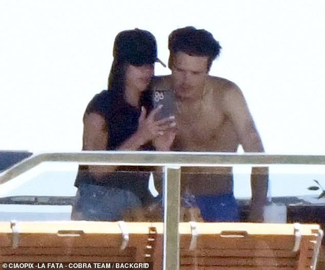 Victoria was later seen catching up with son Cruz as she showed him something on her phone