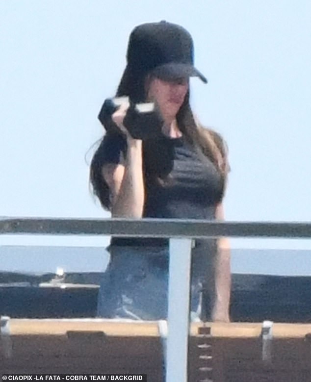 She was pictured pumping iron on the yacht, getting her reps in on the sundeck while casually clad in a plain black T-shirt and denim shorts