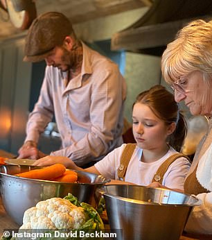 Other snaps taken at his Cotswolds farmhouse show David making a Sunday dinner with his mother and daughter Harper, and cooking up a storm in the kitchen - making a leek pie for his family